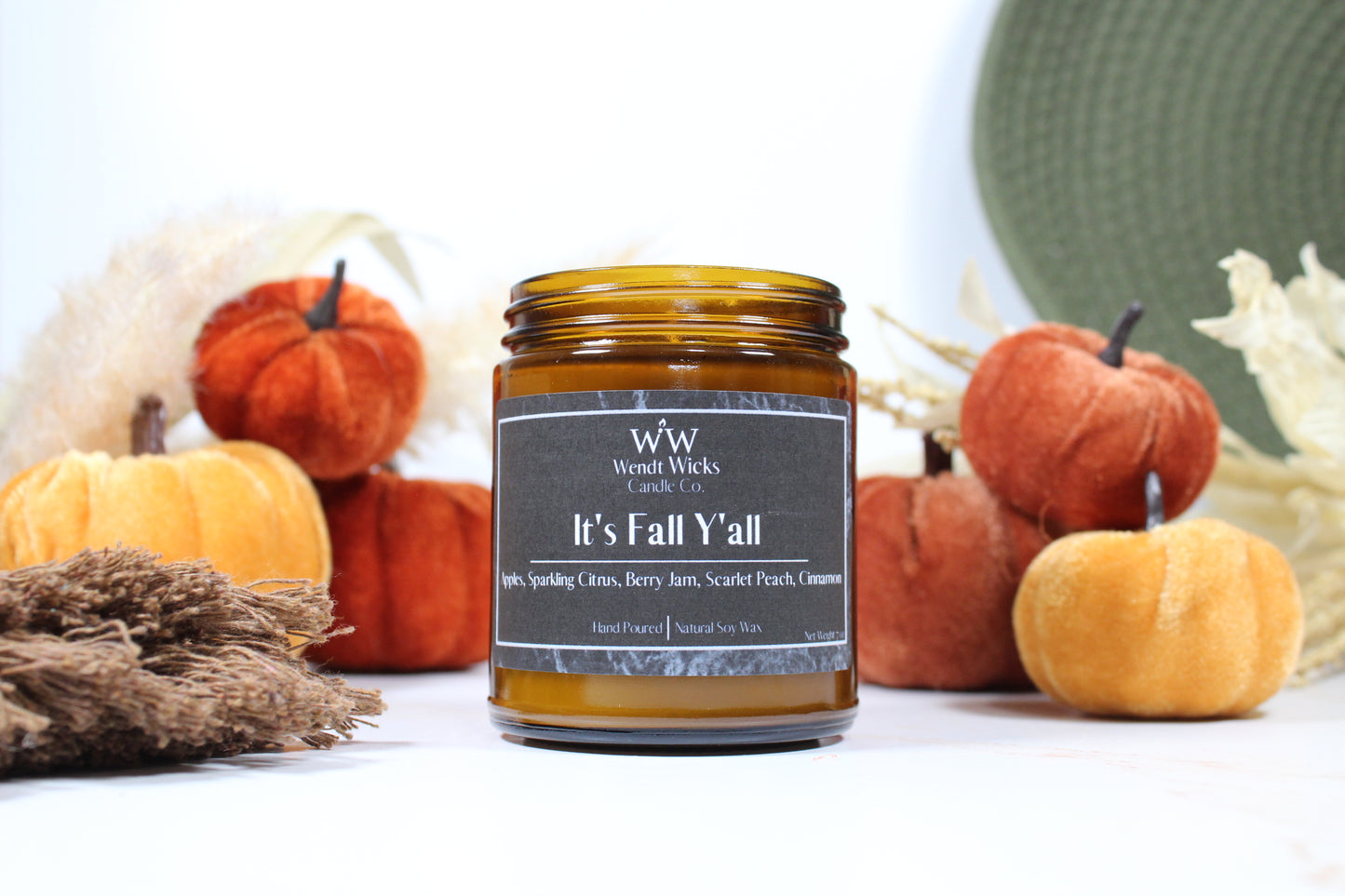 Wendt Wicks amber glass jar candle. Candle labeled 'It's Fall Y'all' with pumpkins and decorative Autumn elements on a white background