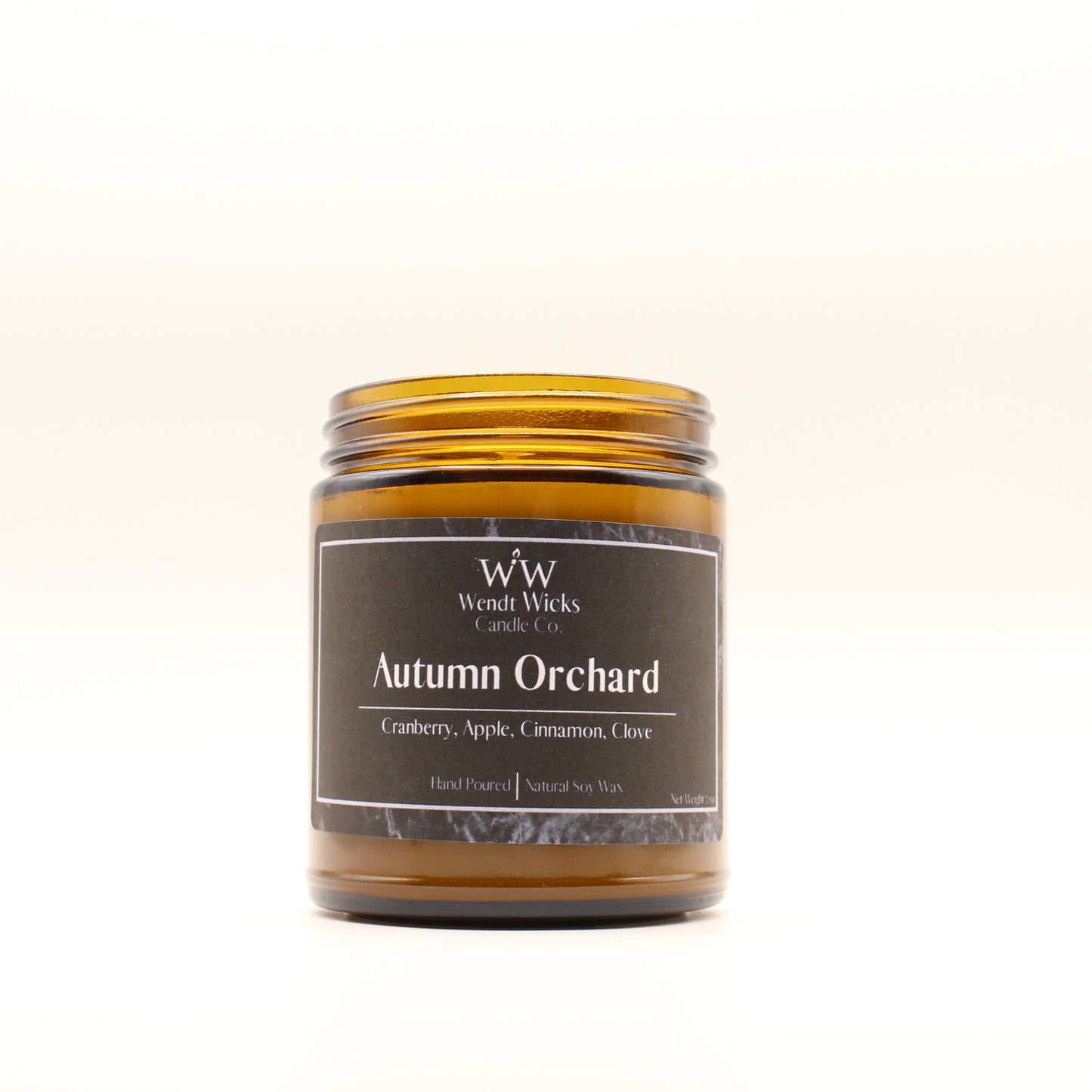Wendt Wicks amber glass jar candle. Candle labeled 'Autumn Orchard' on a white background