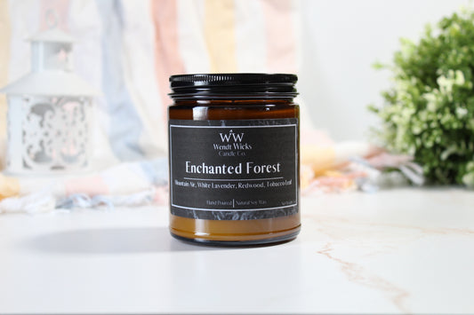 Wendt Wicks Enchanted Forest candle on a white surface with a blurred background