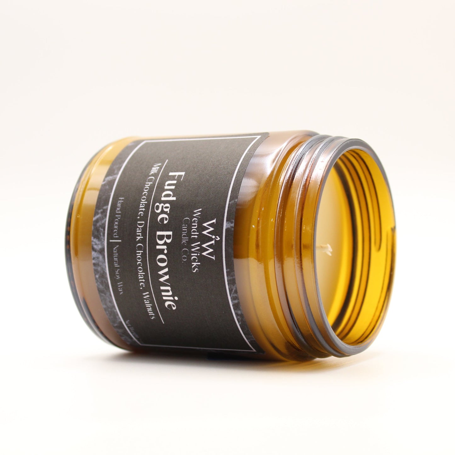 Jar of fudge brownie flavor candle on a white background