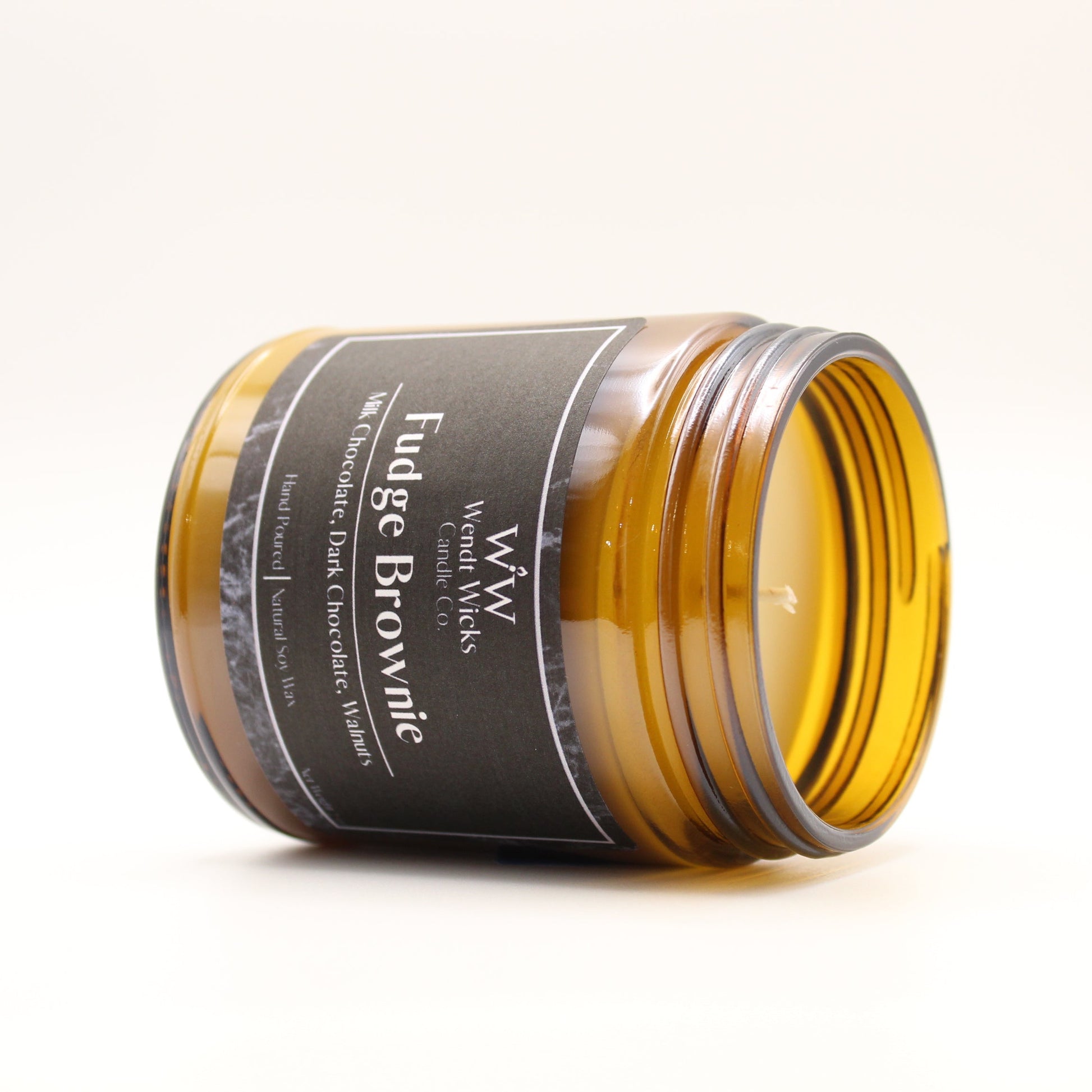 Jar of fudge brownie flavor candle on a white background