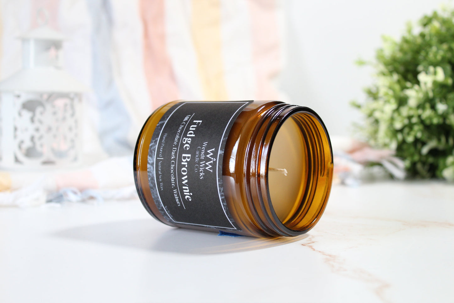 Brown glass jar with a black label on a light surface with a blurred background