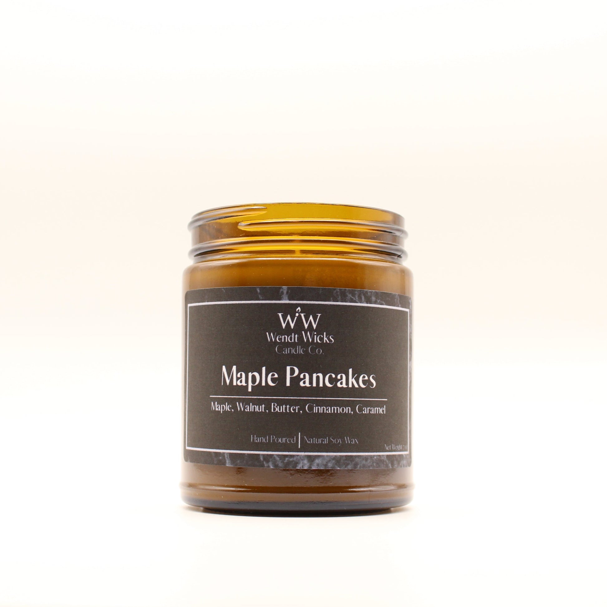 Wendt Wicks amber glass jar candle. Candle labeled 'Maple Pancakes' on a white background