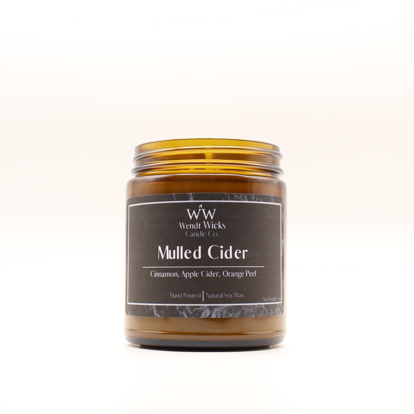 Wendt Wicks amber glass jar candle. Candle labeled 'Mulled Cider' on a white background