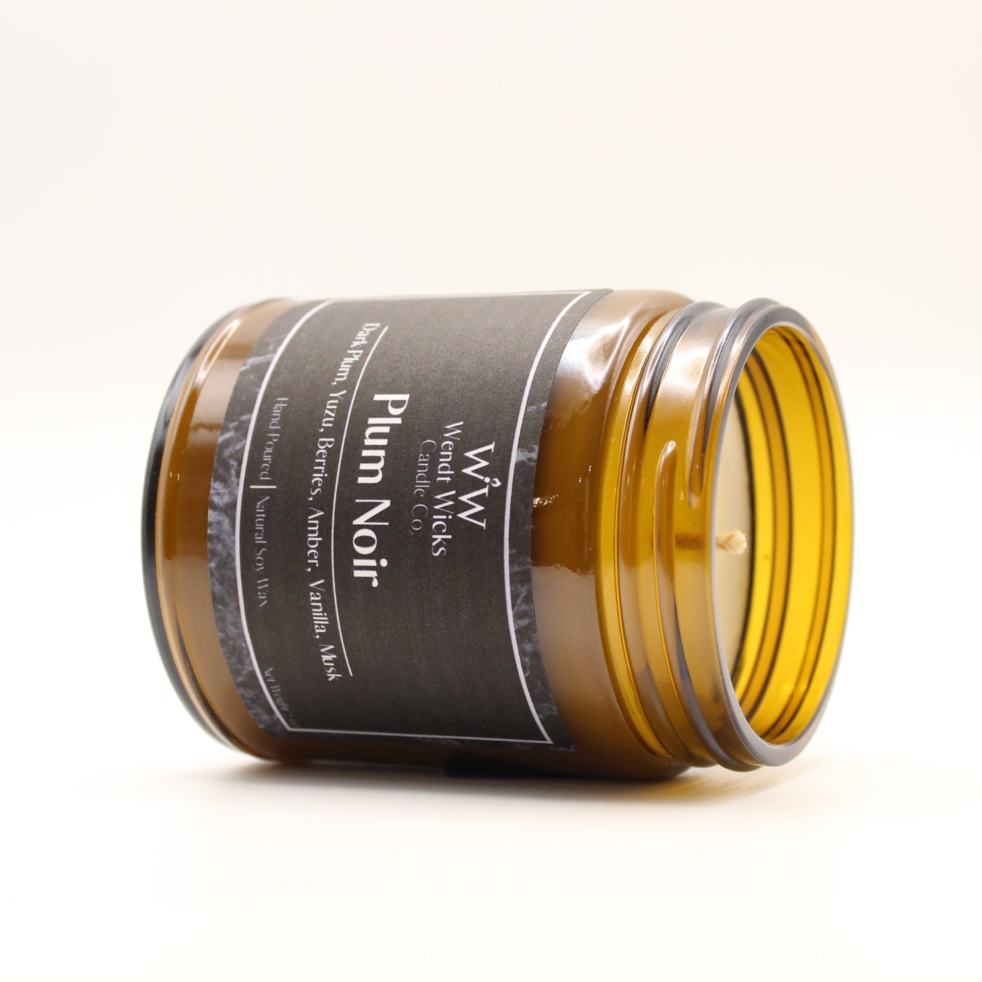 Amber glass jar with a black label on a white background