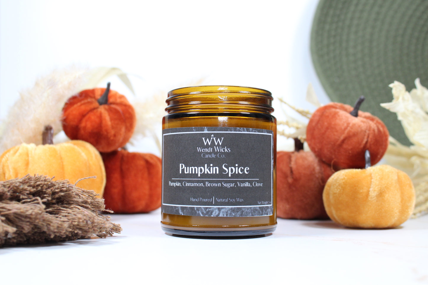 Wendt Wicks amber glass jar candle. Candle labeled 'Pumpkin Spice' with pumpkins and decorative Autumn elements on a white background
