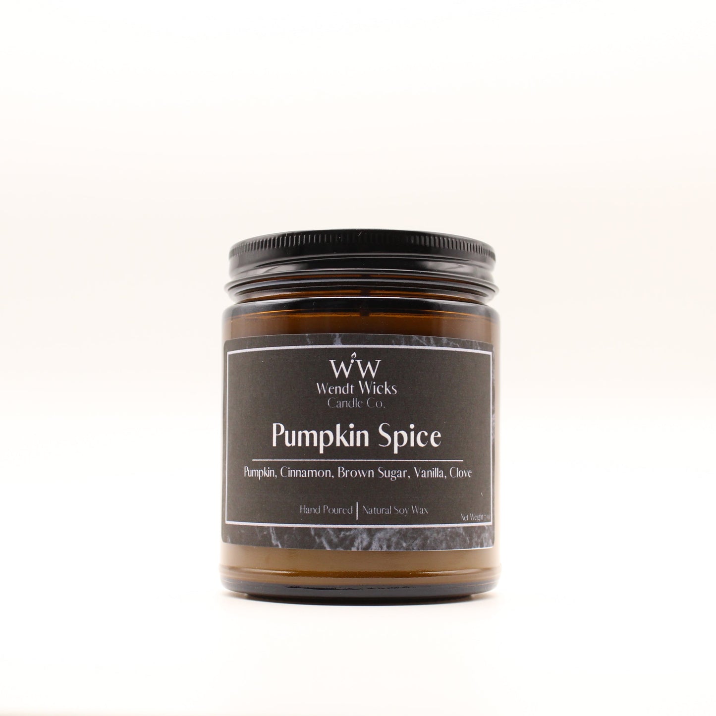 Wendt Wicks amber glass jar candle with black lid. Candle labeled 'Pumpkin Spice' on a white background